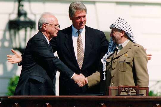 Israeli Prime Minister Yitzhak Rabin, U.S. president Bill Clinton, and PLO chairman Yasser Arafat at the signing of the Oslo Accord (photo: Vince Musi / The White House)